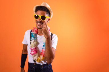 Carnival Brazilian Outfit. Black Man With Carnival Costume Having Fun,  Isolated on Orange Background