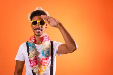 Carnival Brazilian Outfit. Black Man With Carnival Costume Having Fun,  Isolated on Orange Background