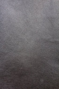 Siyah dokumasız polipropilen kumaş dokusu arka planı. Dokumasız (ya da eğri büğrü) dokunun ve arkaplanının tam kare görüntüsü.