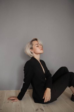 Sarışın, kısa boyalı, kısa saçlı. Saç bakımı, siyah ceketli kadın moda portresi.