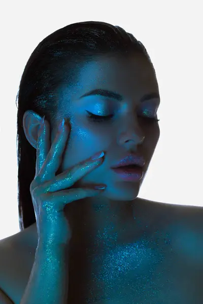 Woman Shimmering Skin Gently Touches Her Face Blue Light Beauty Imagem De Stock