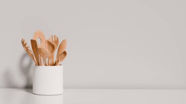 Kaşık ve spatula gibi ahşap mutfak gereçleri beyaz bir kabın içinde dimdik durur. Minimalist gri duvar, mutfak alanının basit ve işlevsel tasarımını geliştirir. 3d hazırlayıcı