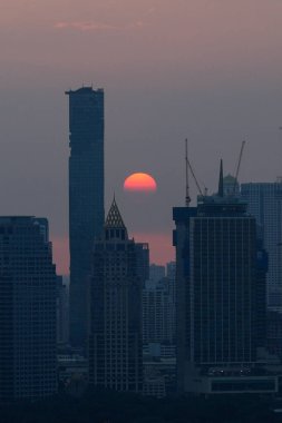 Majestic sunset paints Bangkok skyline in warm hues, creating a breathtaking urban panorama, Thailand clipart