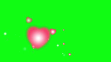 Yeşil ekran arka planında patlayan pembe kalpler.