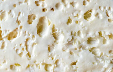 Koyun peyniri parçasının detaylarıyla dolu bir arkaplan.