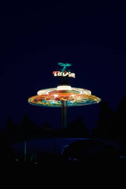 Kouvola, Finland - 26 August 2023: Rotating ride Taifun in amusement park Tykkimaki at night clipart