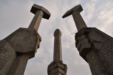 Monument with the hammer, sickle and calligraphy brush of the DPRK. clipart