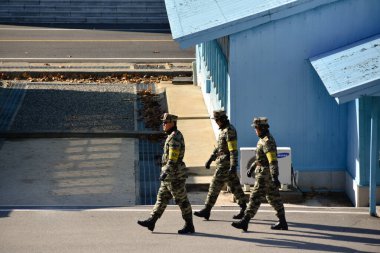 Panmunjom, North Korea - December 26 2018: North Korean soldiers patrol the demilitarized zone at Panmunjom. clipart