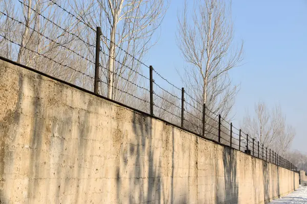 stock image Concrete outer wall and barbed wire fence surrounding Unit 731 in Harbin