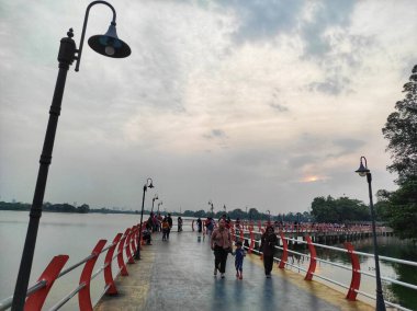 people visiting Cipondoh Lake in the afternoon clipart