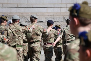 Yakın çekimde, Aberdeen 'deki Silahlı Kuvvetler Günü Geçit Töreni' nin bir katılımcısı tarafından giyilen muhtemelen haki ya da zeytin rengi olan askeri tarzda bir bere veya şapkanın özel ayrıntılarını görüntüler. Başlıkta küçük, koyu bir amblem görünüyor..
