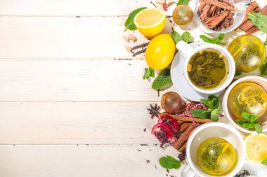 Çeşitli çay topu bombaları. Kurutulmuş çay, fincanlar, limon ve nane içeren farklı çay topları, üst görünüm kopyalama alanı. Modern çay çeşitleri