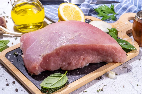 Raw turkey breast filet with spices for cooking. Turkey breast white meat cooking background copy space top view