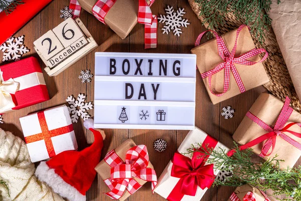 stock image Boxing day sale seasonal promotion background. Various presents gift box with ribbon, with inscription frame Boxing day, block wooden calendar, wrapping holiday paper, Christmas decor, ribbons