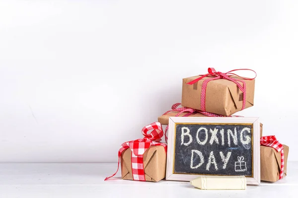 stock image Boxing day sale seasonal promotion background. Various presents gift box with ribbon, with inscription frame Boxing day, block wooden calendar, wrapping holiday paper, Christmas decor, ribbons
