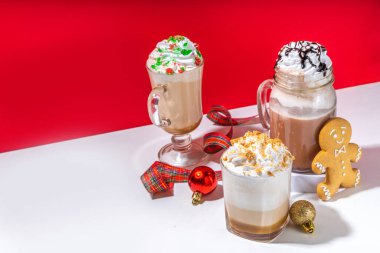 Autumn winter coffee latte set, coffee drink assortment with various topping - gingerbread caramel, mocha chocolate, candy cane peppermint latte, trendy bright high-colored red and white background