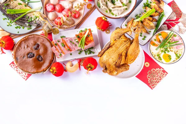 stock image Traditional Chinese lunar New Year dinner table, party invitation, menu background with pork, fried fish, chicken, rice balls, dumplings, fortune cookie, nian gao cake, noodles, chinese decorations