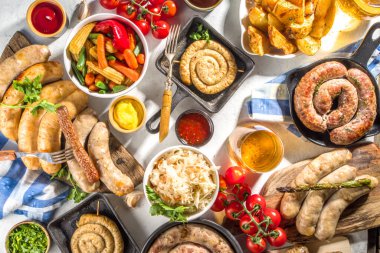 Kızarmış sosis çeşitleri. Bavyera, Frankfurt, Alman ızgara sosisleri, Oktoberfest veya yaz barbekü partisi konsepti, beyaz arka plan fotokopi alanı üst görünümü