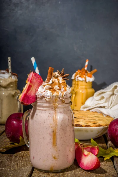 Apple pie smoothie. Crazy shake cocktail with traditional autumn apple pecan flavor, wooden dark background copy space