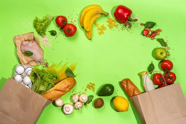 Fresh vegetables, meat, bread fruits in paper grocery bag. Delivery healthy food background. Healthy food cooking ingredients on white,background, Shopping food supermarket and clean vegan eating