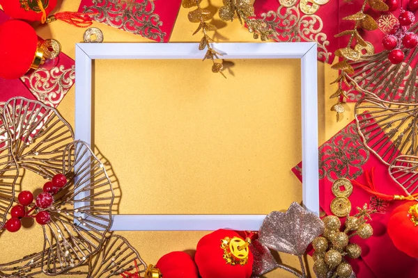 stock image Chinese New Year gold red background. Lunar New Year greeting card flatlay with traditional festival decoration - ginkgo biloba branches decor, twigs, berries, gift envelopes, coins, Chinese lanterns