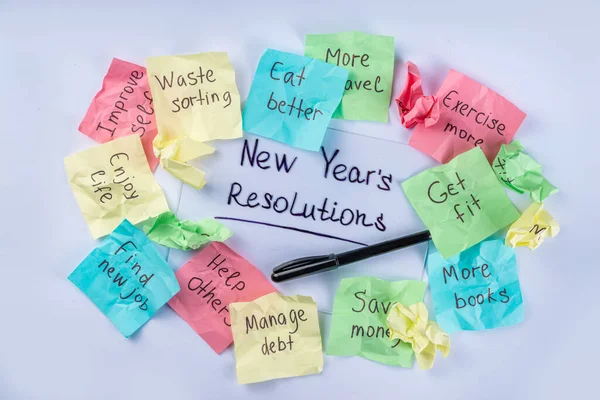 New year goals or resolutions on bright colorful paper stickers. New Year goals List 2023, plan listing of new year beginnings goals and resolutions setting. Flat lay copy space on white background