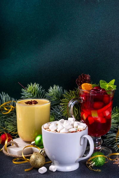 Set of traditional Christmas winter drinks. Christmas bar menu background.Tree cup with mulled wine, eggnog, hot chocolate beverages om dark background with Christmas, New Year decoration copy space