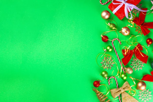 Bright green New Year, Noel, Christmas background with red, green, golden Christmas ornaments, fir tree balls, decorations, Flat lay top view copy space
