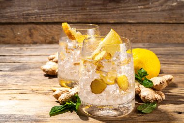 Refreshment Ginger Ale cocktail, Kombucha or Lemon Ginger iced lemonade drink. Sweet and sour alcohol drink copy space