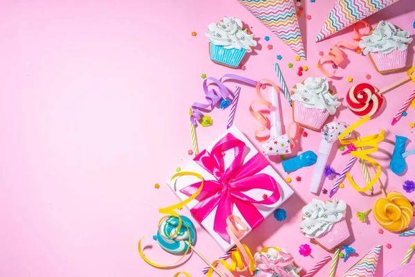 Mutlu yıllar tebrik kartı geçmişi. Renkli tatil aletleri olan düz yatak - doğum günü partisi şapkaları, şişirme makineleri, hediye kutuları, balonlar, buharlı mumlar, pembe arka plan fotokopi alanı