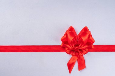 Heart shaped festive red bow and ribbon isolated on white background. Template for brochure or greeting card for valentine, birthday, mother's day