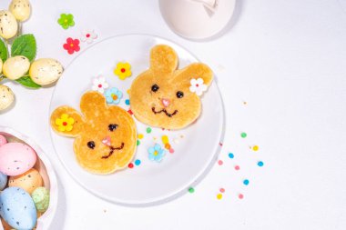 Bunny shaped pancakes for cute Easter holiday, with sugar sprinkles, Funny kids breakfast or brunch