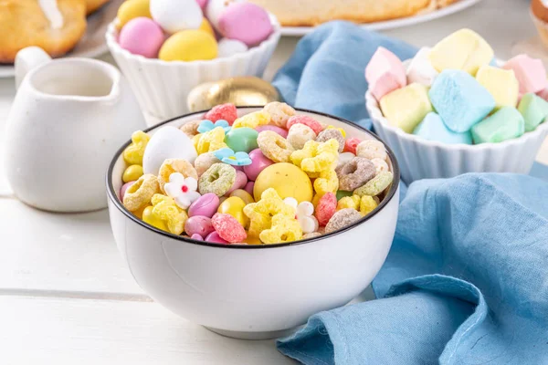 Breakfast easter bunny trail mix. Mixed colorful breakfast cereals and flakes, with chocolate eggs, marshmallow, sugar sprinkles, snacks. Sweets homemade kids Easter morning treats, with milk jug
