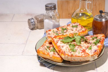 Homemade loaded baguette pizza. Baguette boats. Hot baked casserole sandwich with bacon, mushrooms, tomatoes, chicken mozzarella cheese