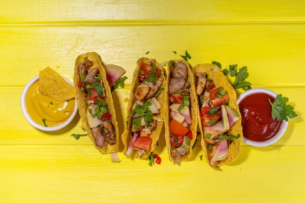 Traditional Mexican street food, fast food background, corn Taco, nachos with meat, vegetables, avocado, beans, corn, salsa. Served with various sauces. Mexican holiday flatlay