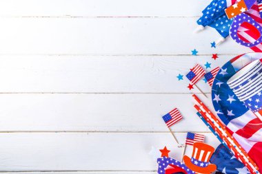Happy Labor Day, Presidents Day, Fourth of July Independent Day, Memorial day, Columbus day background. White wooden background with USA flag color paper fans and decorations, party accessories