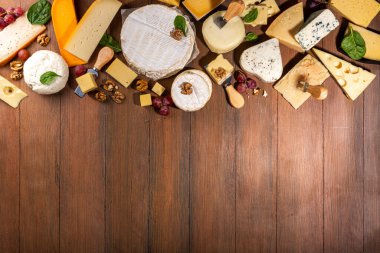 Farklı çeşit peynir seti. Çeşitli peynirli peynir tabağı, üzümlü, fındıklı, peynirli bıçak ve baharatlı, ahşap arka plan kopyalama alanı