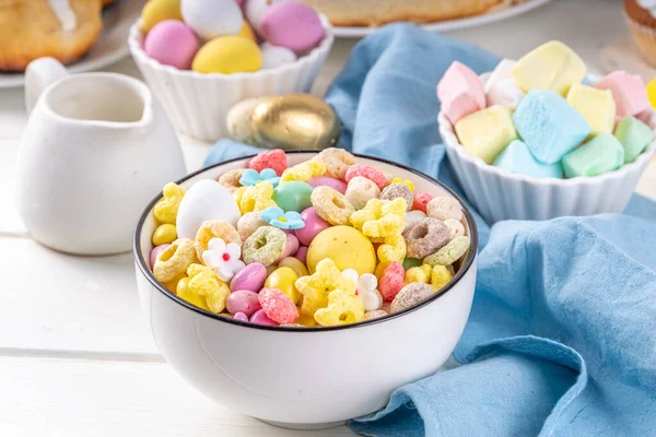 Breakfast easter bunny trail mix. Mixed colorful breakfast cereals and flakes, with chocolate eggs, marshmallow, sugar sprinkles, snacks. Sweets homemade kids Easter morning treats, with milk jug
