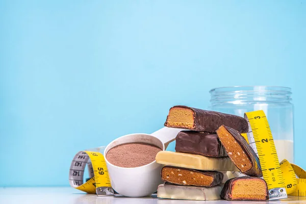 Set of various energy protein bar. Different taste of protein bars and snacks, with protein protein powder jar on high colored background copy space