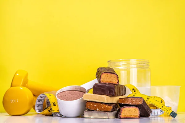 Set of various energy protein bar. Different taste of protein bars and snacks, with protein protein powder jar on high colored background copy space