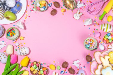 Yüksek renkli Paskalya pastası arka planı, Paskalya indirimi, parti davetiyesi düz yatış, renkli Paskalya yumurtaları, çikolata yumurtaları ve parlak pembe arka plan manzaralı şeker parçacıklı tavşan fotokopi alanı