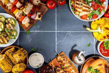 Izgara yaz bbq tabakları. Barda piknik pikniği çeşitli ızgara yiyeceklerle - şiş kebap şiş şiş, ızgara mısır, kızarmış tavuk salata, biftek, sosis, sebze