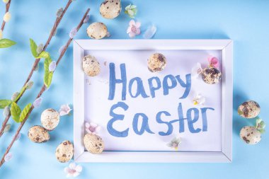 Spring Easter holiday top view background with eggs and willow flowers. Simple Happy Easter  greeting card background with copy space
