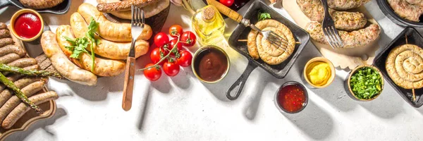 stock image Assortment of different fried sausages. Set with various meat Bavarian, Frankfurt, German grilled sausages, Oktoberfest or summer BBQ party concept, white background copy space top view