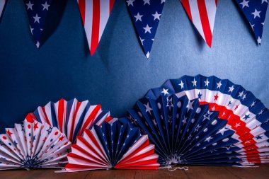 Happy Labor Day, Presidents Day, Fourth of July Independent Day, Memorial day, Columbus day background. Dark blue background with USA flag color paper fans and decorations, party accessories