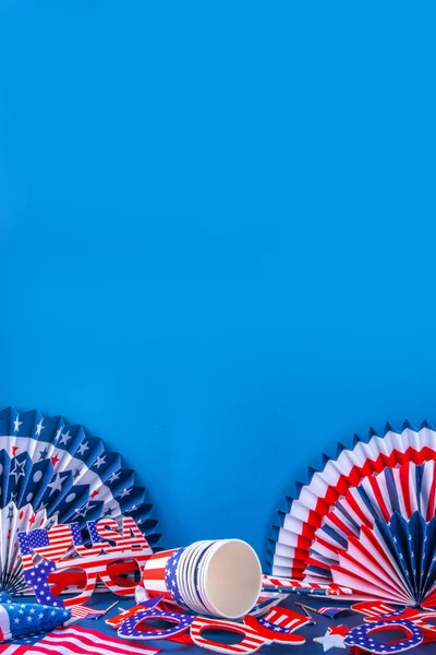 Happy Labor Day, Presidents Day, Fourth of July Independent Day, Memorial day, Columbus day background. Blue background with USA flag color paper fans and decorations, party accessories