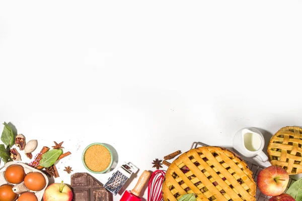 stock image Autumn pie and cakes baking background. Sweet apple, pecan, pumpkin squash pies with baking ingredients and utensils, white table background top view copy space