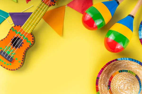 stock image Mexican Cinco de Mayo holiday background with mexican cactus,guitars, sombrero hat, maracas, Bright yellow flat lay with traditional Cinco de Mayo decor and party accessories