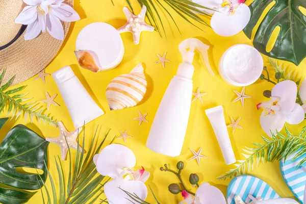 Trendy electric yellow summer cosmetics background. Different skincare, sunscreen cosmetic jars, tubes, moisturizer, cream, serum, masks for face and hands, top view copy space