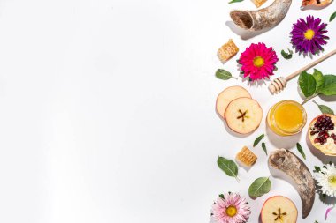 Happy Rosh Hashanah background. jewish New Year  Rosh Hashana holiday postcard greeting background, with traditional religion symbols - apple, honey, pomegranate, shofar, flatlay copy space